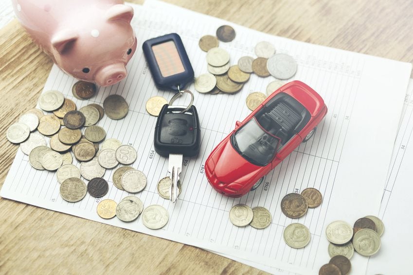 piggy bank and car with money over new finance papers
