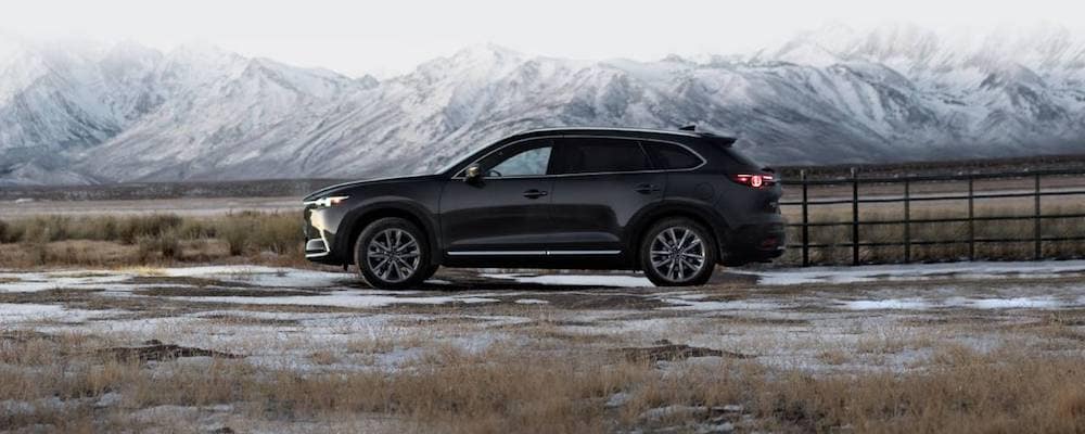 Image of a black 2019 Mazda CX-9 in front of a mountain backdrop.