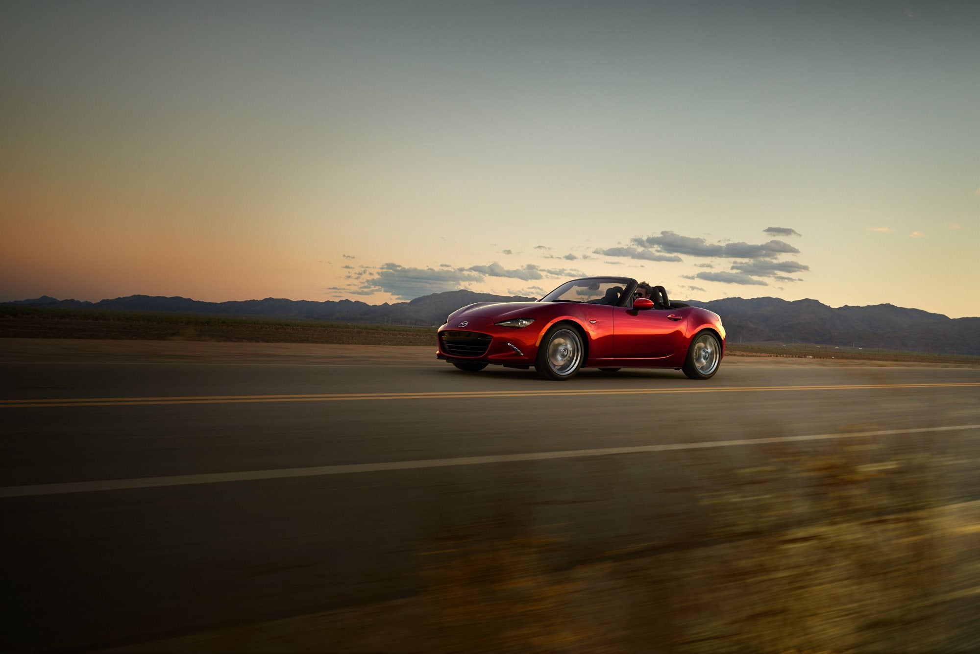 2018 Red MX-5 Miata driving at sunset